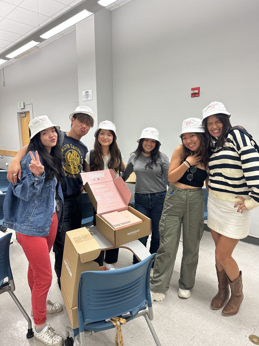 Azure consultants in matching bucket hats during a Monday Haircare collab